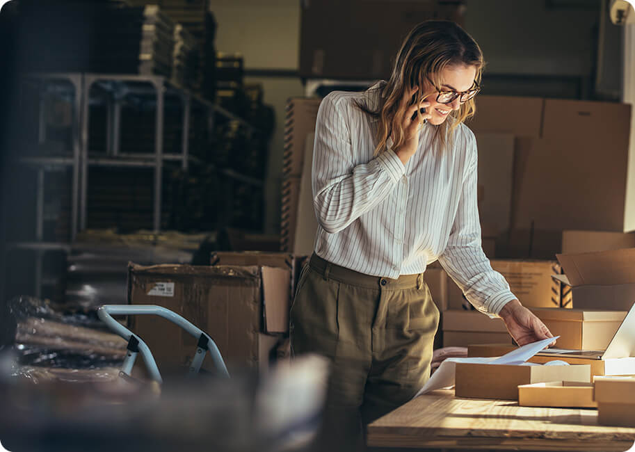 woman talking on a cell phone looking at papers